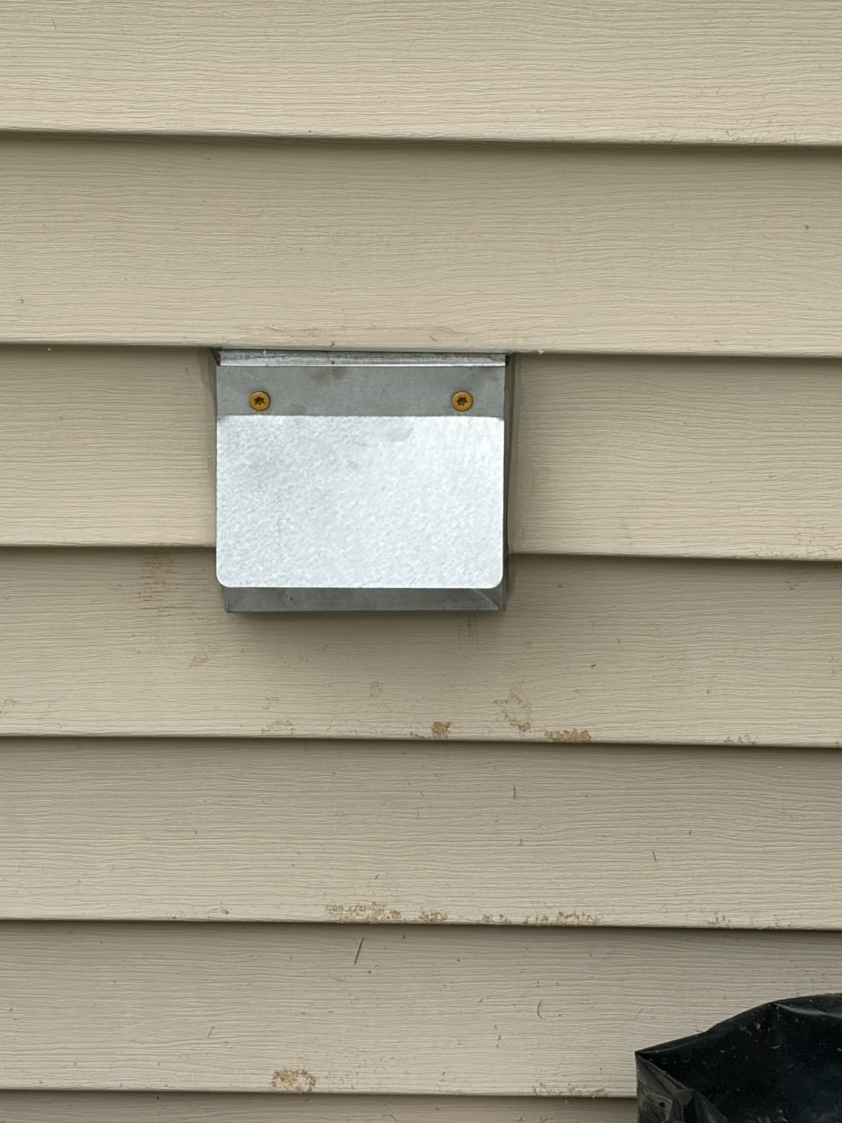 Close-up of the intake vent cover fitted during follow-up on the Bennington pellet stove installation.