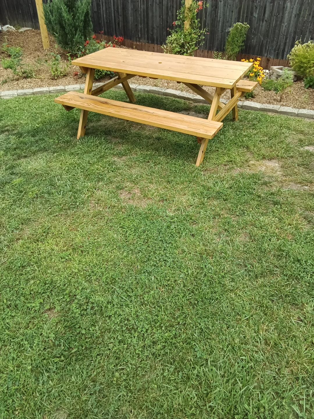 Beechwood-built picnic table on grass before the gravel pad was installed in Jaffrey, NH.