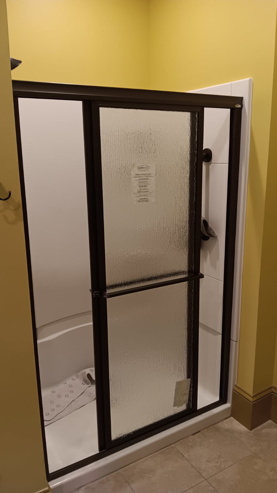 Completed shower enclosure with one sliding door open in West Chesterfield, NH.