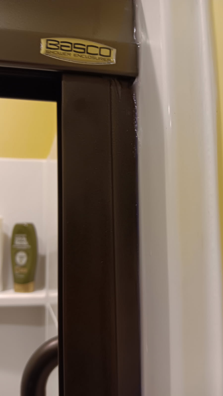Close-up of the fitted shower door jamb and trim at the existing surround in West Chesterfield, NH.